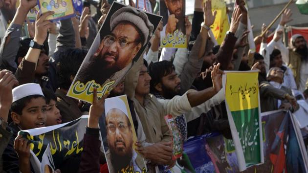 Jamaat-ud-Dawa supporters shout slogans during a protest after its leader Hafiz Saeed was placed under house arrest in Lahore. (AFP File) Jamaat-ud-Dawa supporters shout slogans during a protest after its leader Hafiz Saeed was placed under house arrest in Lahore. (AFP File)