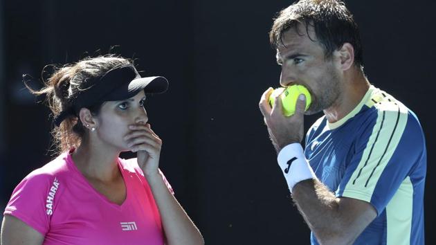 Sania Mirza and Ivan Dodig of Croatia talk tactics during their mixed doubles' final against Abigail Speers of the US and Juan Sebastian Cabal of Colombia at the Australian Open tennis championships in Melbourne.(AP) Sania Mirza and Ivan Dodig of Croatia talk tactics during their mixed doubles' final against Abigail Speers of the US and Juan Sebastian Cabal of Colombia at the Australian Open tennis championships in Melbourne.(AP)