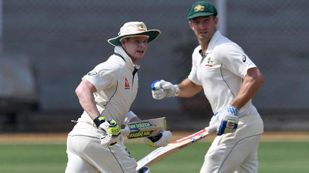 Australia's captain Steve Smith (L) and Shaun Marsh run between the wickets during the first day of three-day practice cricket match between India 'A' and Australia at The Brabourne Cricket Stadium.(AFP)