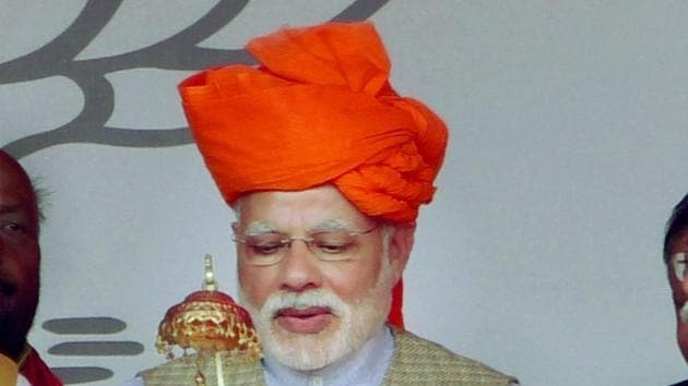 Prime Minister Narendra Modi is presented with a Buddha statuette at a rally in Lakhimpur Kheri, Uttar Pradesh.(PTI file photo)