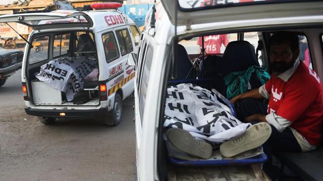 Pakistani volunteers prepare to move the bodies of suspected militants killed in an overnight raid on their hideouts by security forces, at a hospital in Karachi, following the bomb attack on the shrine of Sufi saint Lal Shahbaz Qalandar in Sindh province.(AFP Photo)