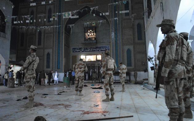 Pakistani paramilitary soldiers stand alert after the deadly suicide attack at the shrine of Lal Shahbaz Qalandar in Sehwan on Thursday.(AP)