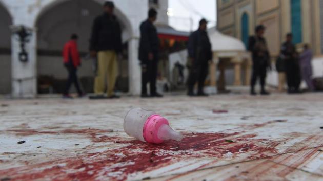 Pakistani security personnel stand guard at the 13th century Sufi shrine of Lal Shahbaz Qalandar a day after a suicide attack in the town of Sehwan in Sindh province, 200 km northeast of provincial capital Karachi, killed 81 people, including 20 children.(AFP Photo)