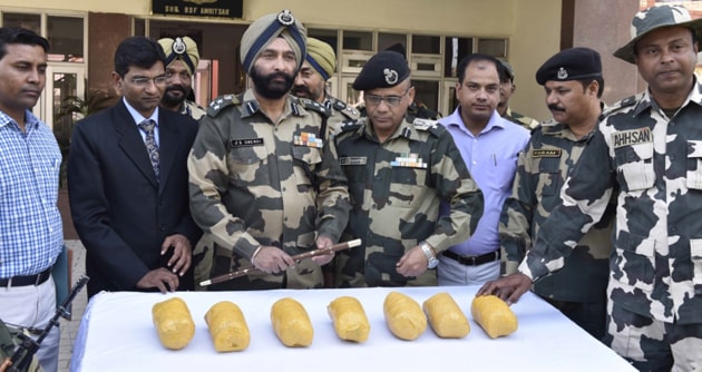 BSF officials and officials of Narcotics Control Bureau showing the packets of heroin seized from Amritsar sector, on Saturday. (Gurpreet Singh/Hindustan Times) BSF officials and officials of Narcotics Control Bureau showing the packets of heroin seized from Amritsar sector, on Saturday. (Gurpreet Singh/Hindustan Times)