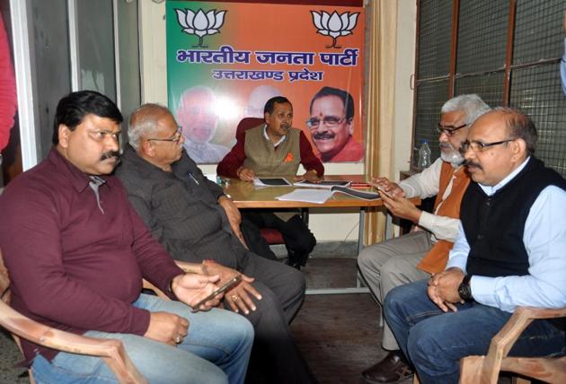 BJP workers wait anxiously for news from Delhi at the party office in Dehradun on Saturday.(Vinay Santosh Kumar/HT) BJP workers wait anxiously for news from Delhi at the party office in Dehradun on Saturday.(Vinay Santosh Kumar/HT)
