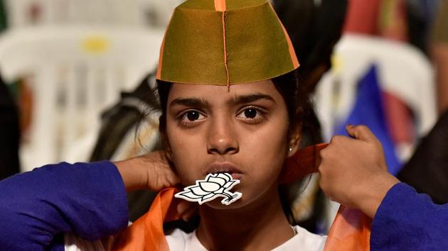 A young BJP supporter during the rally. (Arijit Sen/HT PHOTO) 