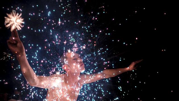 A villager performs the 'eating flowers' ritual. Villagers in eastern China have a unique way of washing away the taint of evil spirits -- by bathing in a shower of scorching sparks. (Johannes EISELE / AFP)