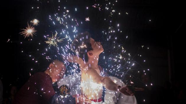 A Fangshan villager performs the ‘eating flowers’ ritual - bathing in a shower of scorching sparks - to wash away the taint of evil spirits. (Johannes EISELE / AFP)