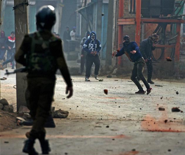 Police chasing away stone pelters during a clash at Batmaloo in central Srinagar. (PTI File Photo) Police chasing away stone pelters during a clash at Batmaloo in central Srinagar. (PTI File Photo)