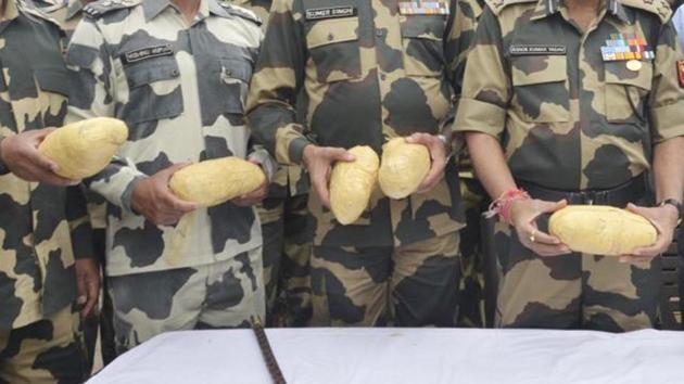 In this file photo from April 2016, officials show seized nine kg of heroin recovered from Pak smugglers at the Border Out Post Bheropal Sector Amritsar.(Sameer Sehgal /Hindustan Times)