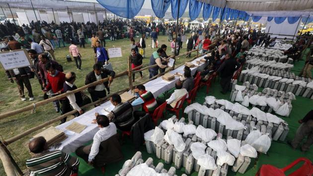 Election officers gather at a distribution center to receive electronic voting machines for their respective polling stations on the eve of polling in Lucknow, India, Saturday, February 18, 2017.(AP Photo)