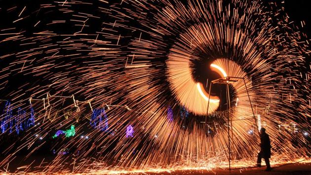 A folk artist performs the art of making shower of melted iron sparks at an event celebrating the Lantern Festival in Anyang, Henan province in China on February 11, 2017. (REUTERS)