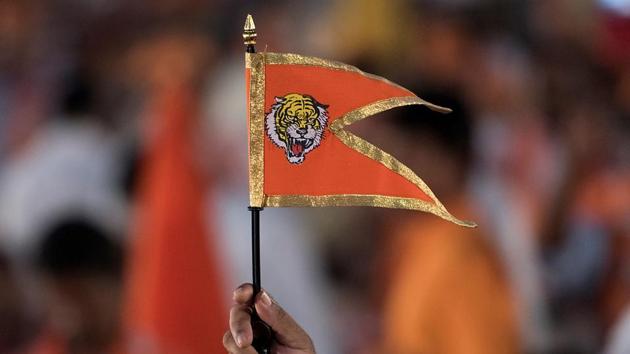 A Shiv Sena supporter waves a party flag  during a rally at the  BKC ground. (Satish Bate/HT PHOTO) 