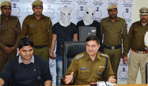 The police parade the two persons arrested for looting the liquor store.(HT PHOTO) The police parade the two persons arrested for looting the liquor store.(HT PHOTO)