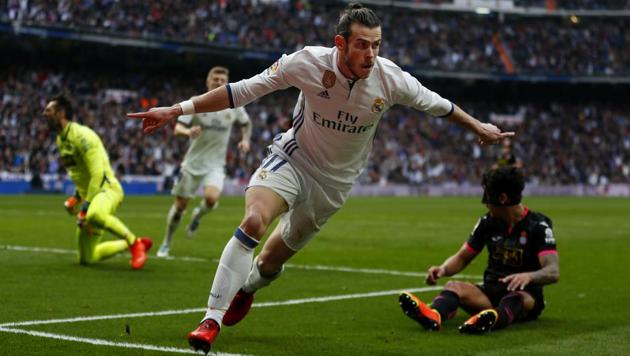 Real Madrid's Gareth Bale celebrates after scoring against Espanyol during their Spanish La Liga match at the Santiago Bernabeu stadium in Madrid on Saturday.(AP)