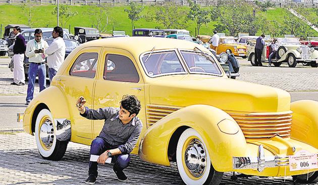 A youth clicks a selfie alongside a vintage car at the Buddh racing circuit on Sunday. (Sunil Ghosh/HT PHOTO) A youth clicks a selfie alongside a vintage car at the Buddh racing circuit on Sunday. (Sunil Ghosh/HT PHOTO)
