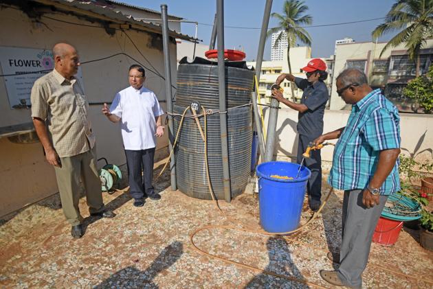 Authorities of t Michael’s church in Mahim explain the functioning of the biogas plant.(Pratik Chorge/HT PHOTO)