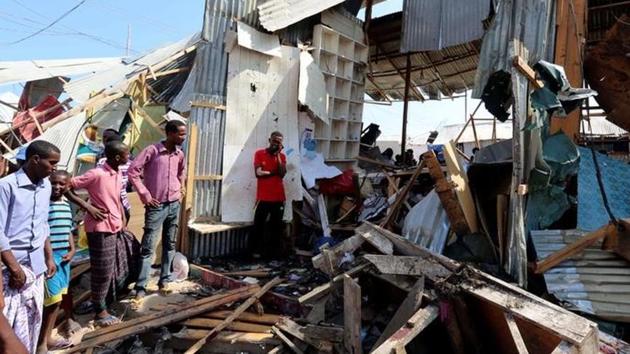 Traders look at a stall destroyed in the suicide bomb explosion at the Wadajir market in Madina district of Mogadishu on Sunday.(Reuters)