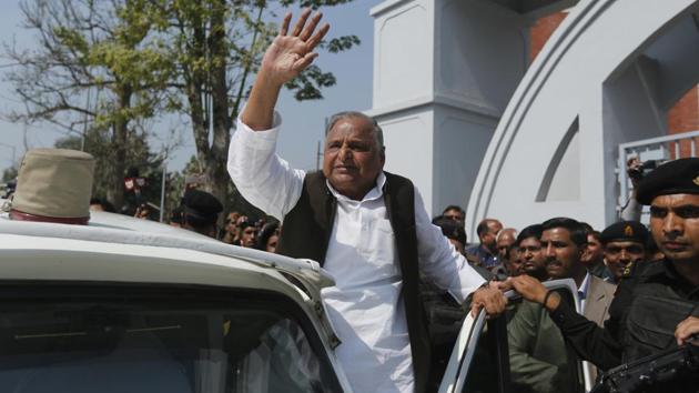 Samajwadi Party leader Mulayam Singh Yadav waves to supporters after casting his vote at a polling station in Saifai, in Etawah on Sunday.(AP)