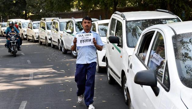 A driver holds a placard to protest against withdrawal of incentives by the app-based cab aggregators during the Ola and Uber taxi drivers strike on Fifth day, at Jantar Mantar in New Delhi on February 14. (PTI) A driver holds a placard to protest against withdrawal of incentives by the app-based cab aggregators during the Ola and Uber taxi drivers strike on Fifth day, at Jantar Mantar in New Delhi on February 14. (PTI)