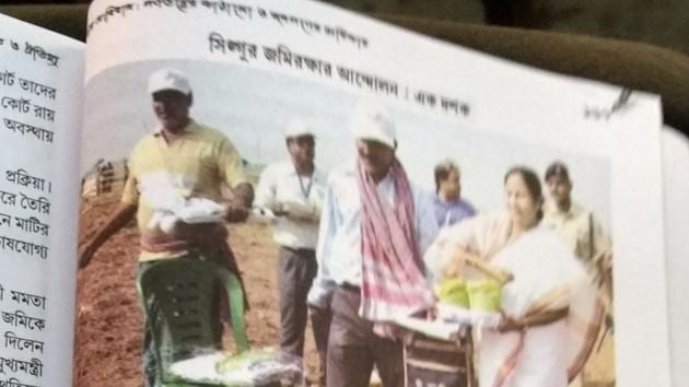 A page of the text book. There are five pictures of chief minister Mamata Banerjee who is seen sowing seeds in Singur here. (HT Photo) A page of the text book. There are five pictures of chief minister Mamata Banerjee who is seen sowing seeds in Singur here. (HT Photo)