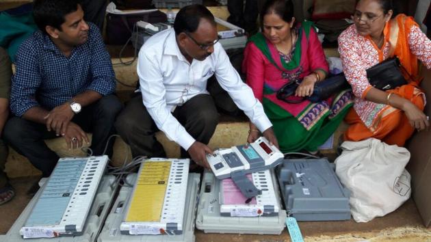 UNDERSTANDING THE MACHINATIONS: EVMs being distributed at a booth in Thane. (PRAFUL GANGURDE)