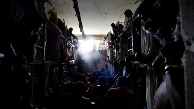 Prisoners cram up to watch TV in their crowded cell. Severe overcrowding is partly due to rampant corruption, as judges, prosecutors and lawyers join in creating a market for bribes, said Brian Concannon, director of the non-profit Institute for Justice and Democracy in Haiti. (Dieu Nalio Chery/AP)