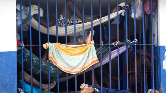 Prisoners rest in makeshift hammocks inside the National Penitentiary in downtown Port-au-Prince, Haiti. Inmates in Haiti's largest prison are crammed shoulder-to-shoulder in cellblocks so overcrowded they have to sleep in makeshift hammocks suspended from the ceiling or squeeze four to a bunk. (Dieu Nalio Chery/AP)