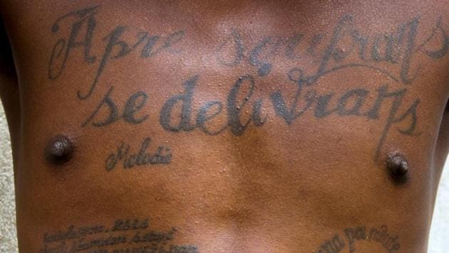 Tattoos on the chest and abdomen of a prisoner incarcerated at the National Penitentiary in downtown Port-au-Prince, Haiti. The tattoo on his chest reads in Haitian Creole: "After suffering is deliverance." (Dieu Nalio Chery/AP)