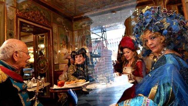 The carnival was revived in 1979 with great success and nowadays it is a good excuse to don a mask and costume, parade around the city and enjoy the live music in the main squares of the city. (Alberto PIZZOLI / AFP)