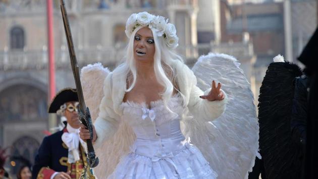 A carnival-goer waits for the Flight of the Angel which is the official opening of the Venice Carnival. (Andre Merola / AP)