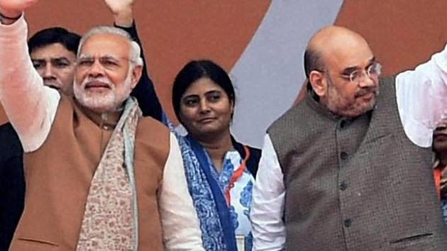 Prime Minister Narendra Modi with BJP president Amit Shah and Union home minister Rajnath Singh at a campaign rally in Lucknow.(PTI file photo)