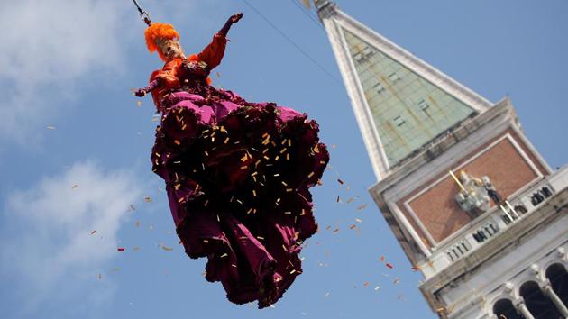 A woman dressed as an ‘angel’ descends on Saint Mark's Square during the Venice Carnival. (Alessandro Bianchi / REUTERS)