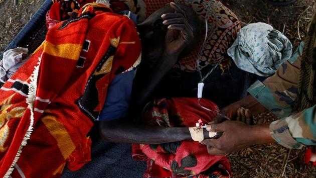 A sick man is treated by a United Nations Mission in South Sudan peacekeeper during a foot patrol near Bentiu. (REUTERS Photo)