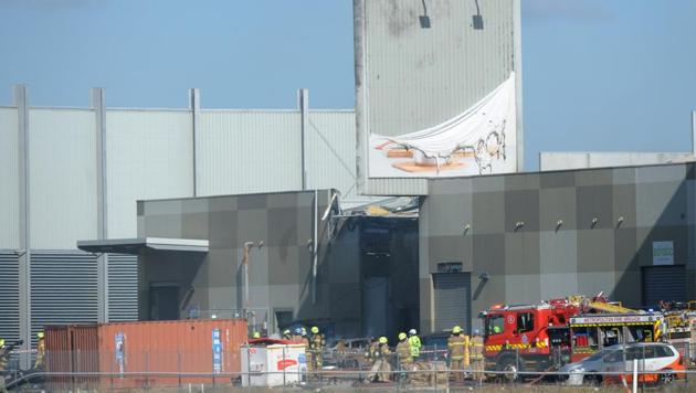 Fire crew at the scene where a light plane crashed into the back of a building at Essendon airport in Melbourne, Australia. (Reuters Photo)