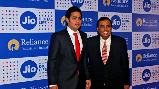 Mukesh Ambani (R), chairman of Reliance Industries Ltd, poses with his son Akash before addressing the company's annual general meeting in Mumbai, in September(Reuters file photo)