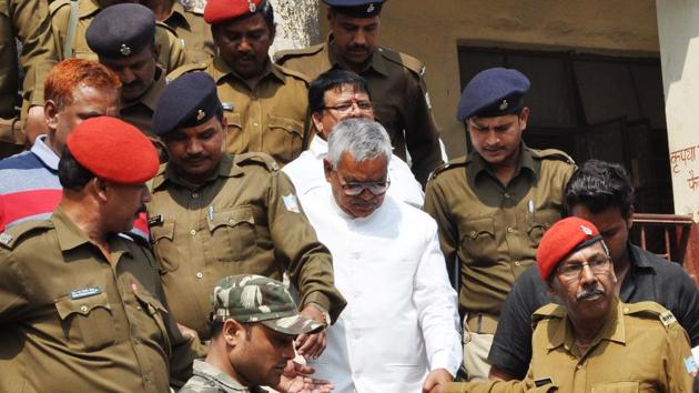 Police taking Ramadheer Singh ,Central President of Janata Mazdoor Sangh and uncle of Jharia MLA Sanjeev Singh, to jail . He was sentenced to life imprisonment by Dhanbad court three years ago and was hence absconding.(Bijay/ HT Photo)