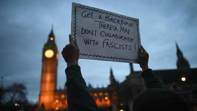 A protestor holds a placard near the Houses of Parliament during an anti-Trump protest in London on February 20, 2017.(AFP)