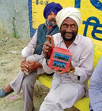 A farmer holding an auto-start switch used for tubewells(HT Photo)