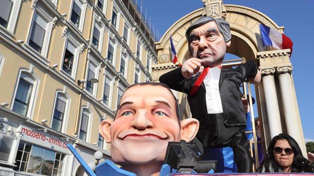 A float depicting French presidential election candidate for the right-wing Les Republicains (LR) party Francois Fillon and French presidential election candidate for the left-wing French Socialist (PS) party Benoit Hamon parade in the streets of Nice for the 133rd edition of the Nice Carnival . (VALERY HACHE / AFP)