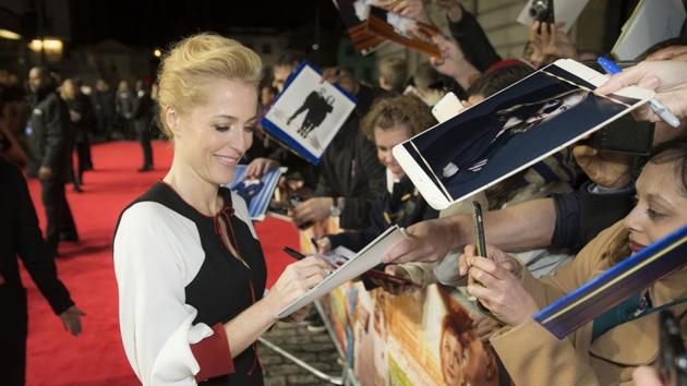 Actress Gillian Anderson signs autographs for fans. (Joel Ryan/Invision/AP)