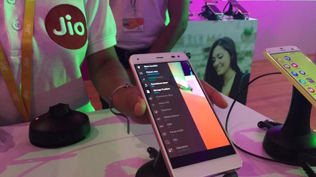 A Reliance employee demonstrates Jio LYF phone at their headquarters on the outskirts of Mumbai. (Reuters) A Reliance employee demonstrates Jio LYF phone at their headquarters on the outskirts of Mumbai. (Reuters)