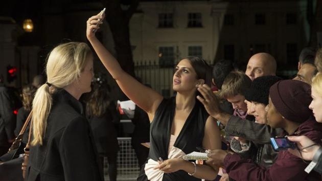 Huma Qureshi poses for photographs for fans during the premiere for the film Viceroy's House in London, Tuesday. (Joel Ryan/Invision/AP)