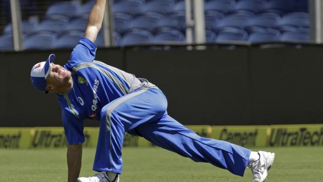 Australia's David Warner stretches during a practice session ahead of their first Test in Pune on Wednesday.(AP)