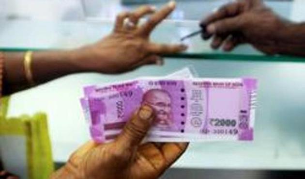 An Indian woman holds Rs 2000 notes as she has her finger marked with indelible ink at a bank in Chennai. The tax department has been closely monitoring bank deposits since the demonetisation of Rs 500 and Rs 1000 notes on November 8. (AFP) An Indian woman holds Rs 2000 notes as she has her finger marked with indelible ink at a bank in Chennai. The tax department has been closely monitoring bank deposits since the demonetisation of Rs 500 and Rs 1000 notes on November 8. (AFP)
