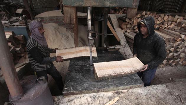 Workers at the factory turn the willows - known as clefts - into finished articles suitable for playing. (Waseem Andrabi / HT Photo)