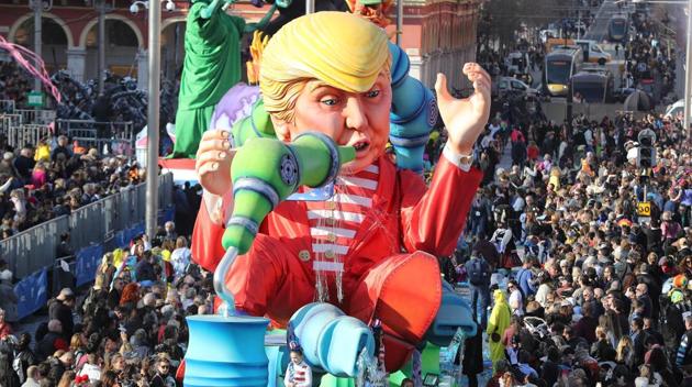 People look at the float ‘Wind of Change’ depicting US President Donald Trump as it parades for the 133rd edition of the Nice Carnival in Nice, southeastern France. The Nice carnival runs until February 25, 2017 under the theme "The King of Energies" (VALERY HACHE / AFP)