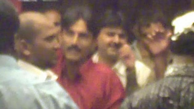 A TV grab shows Chhota Rajan aides Sunil Poddar (in red shirt) and Farid Tanasha (behind Poddar) at a party in a Chembur club. (File photo) A TV grab shows Chhota Rajan aides Sunil Poddar (in red shirt) and Farid Tanasha (behind Poddar) at a party in a Chembur club. (File photo)