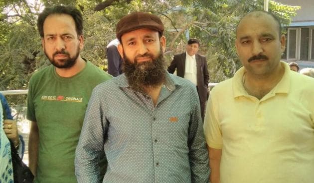 Tariq Ahmad Dar (wearing a cap) with his family members after he was released from Tihar.(HT Photo)