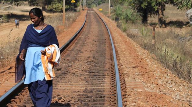 Savitri tiptoes along the track, making sure that everything, right from fishplates — metal pieces that hold adjacent rails — to the tracks on which at least two dozen goods and a passenger train run everyday, are in order. (HT Photo) Savitri tiptoes along the track, making sure that everything, right from fishplates — metal pieces that hold adjacent rails — to the tracks on which at least two dozen goods and a passenger train run everyday, are in order. (HT Photo)